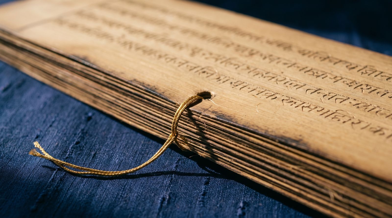 Palm-leaf manuscript bound with a gold cord